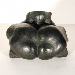 Black colored sculpture of a two oval shapes forming a heart next to each other resembling a human buttocks. 
