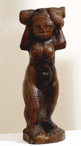 Medium brown, wooden sculpture with pock mark detailing of a rounded female form carrying a small childlike form upon her shoulders and behind her face.  